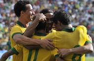 Brazilian national Ronaldinho celebrates with teammate after scoring a goal against Bolivia during their friendly football match in Santa Cruz, Bolivia on April 6, 2013.